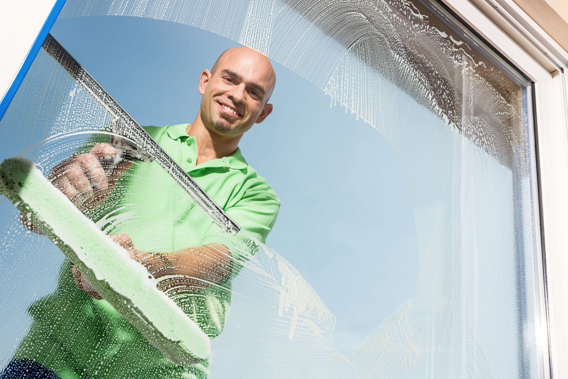 Putzkraft führt eine Fensterreinigung durch